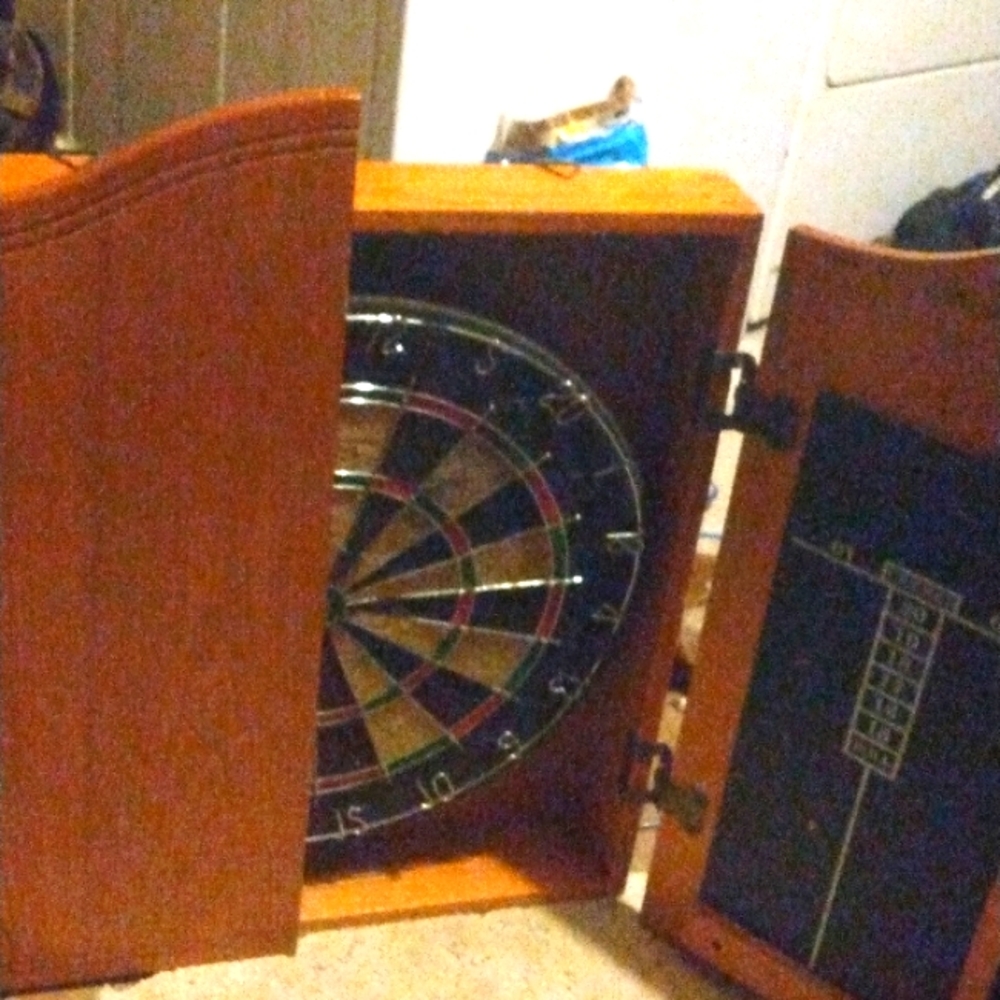 It's a solid oak dart board in a wall hanging shelf for man cave or bar room or